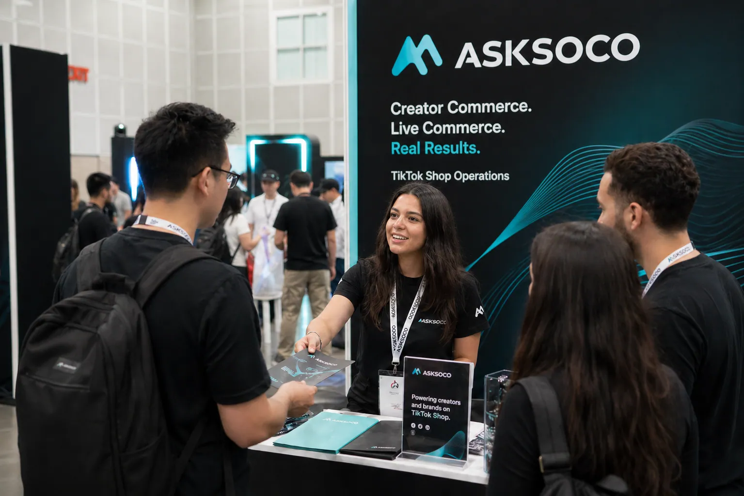 AskSoco team meeting brand attendees at an industry expo booth, with the booth backdrop showing creator commerce, live commerce, and TikTok Shop operations.