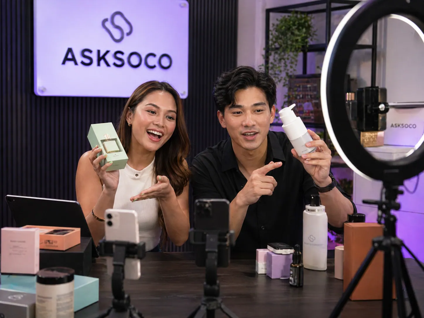 AskSoco hosts presenting product on camera in a live commerce studio.